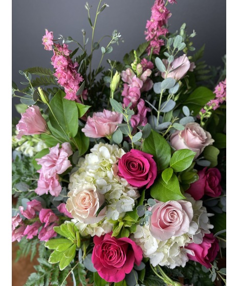 A floral arrangement featuring pink and white blooms, including blush roses, white lilies, and pink hydrangeas. Perfect for elegant and joyful celebrations.