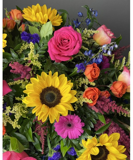 A colorful bouquet featuring a designer’s mix of bright, seasonal flowers in a variety of colors, perfect for Valentine’s Day or as a vibrant gift.