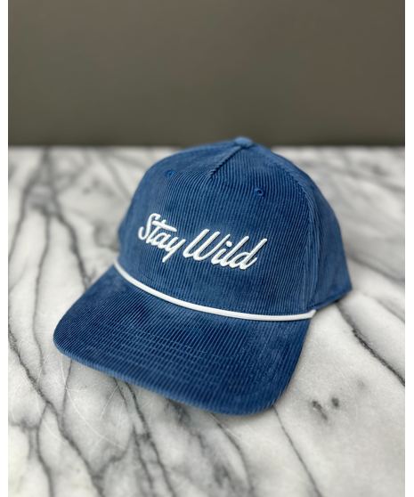 A corduroy hat with an embroidered ‘Stay Wild’ logo, white rope detail, and adjustable strap. Available in four colors.