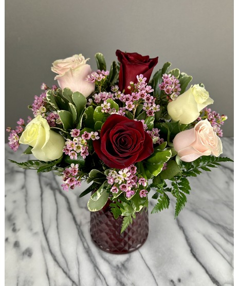 A bouquet of mixed-color roses featuring a variety of shades, including pinks, reds, and yellows. Colors may vary based on seasonal availability. Arranged for Valentine’s Day.