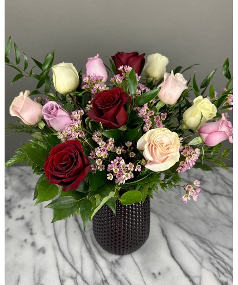 A bouquet of mixed-color roses featuring a variety of shades, including pinks, reds, and yellows. Colors may vary based on seasonal availability. Arranged for Valentine’s Day.