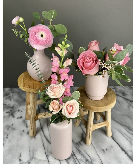 A set of individual vases, each holding a single-stem rose with greenery. Available in single, 2, or 3 vase options for a minimalist and elegant look.