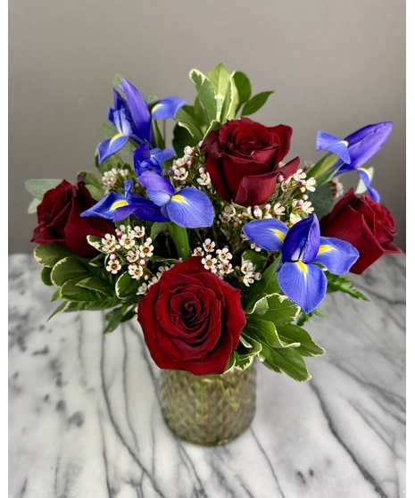 A floral arrangement featuring roses and irises.