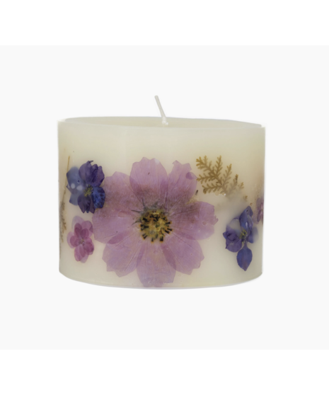 A botanical candle featuring real lavender accents with a calming lavender scent, available in two sizes: Petite Oval (60 hours) and Medium Round (200 hours).