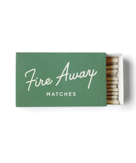 Two colorful matchboxes: green with “Fire Away” and red with “Light It Up,” each containing 50 safety matches for home use.