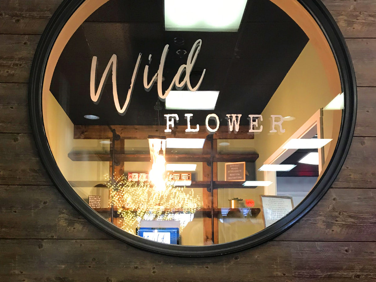 Peering through the circular window that welcomes guests to our storefront